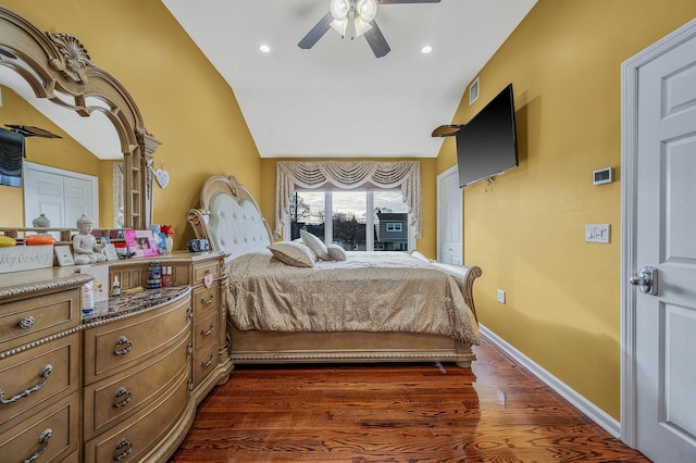 bedroom with dark hardwood / wood-style floors, ceiling fan, and lofted ceiling