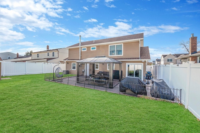 back of house featuring a lawn and a patio