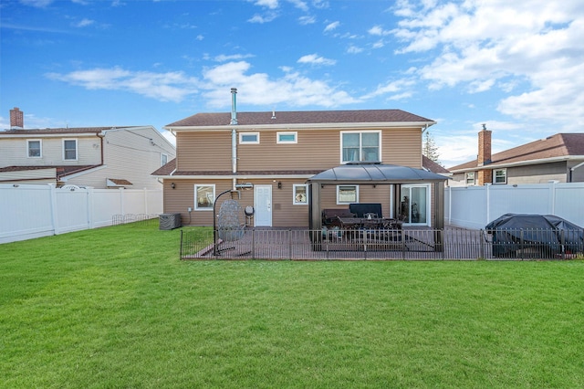 rear view of house with a lawn, cooling unit, a gazebo, and a patio