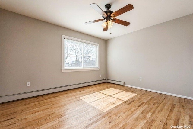 spare room with a baseboard radiator, ceiling fan, and light wood-type flooring