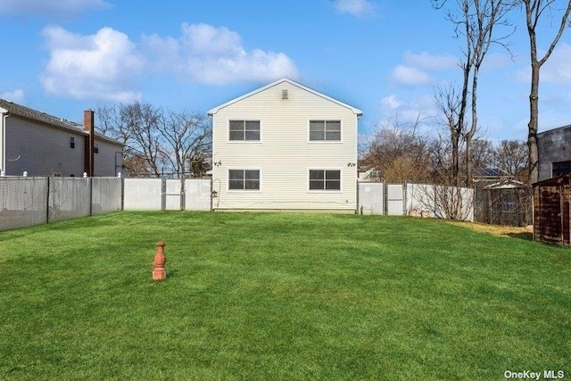 back of house with a lawn