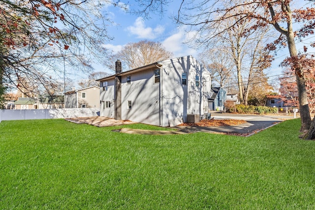 rear view of property featuring a yard