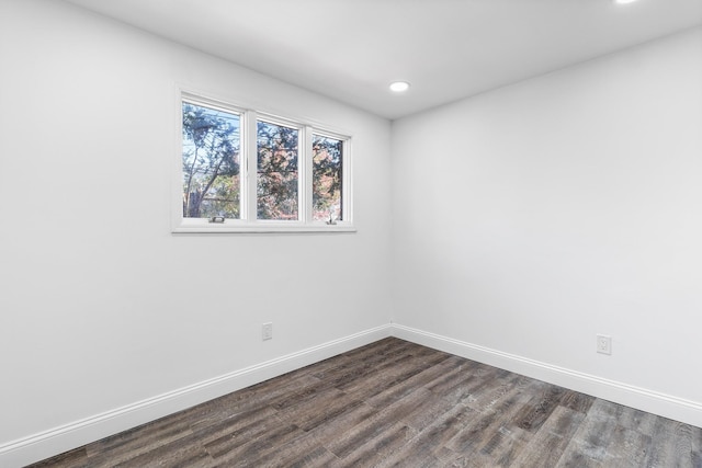 spare room with dark wood-type flooring