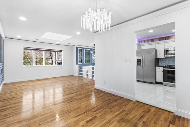 unfurnished living room featuring light hardwood / wood-style floors and ornamental molding