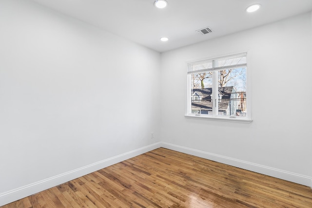 unfurnished room with hardwood / wood-style floors