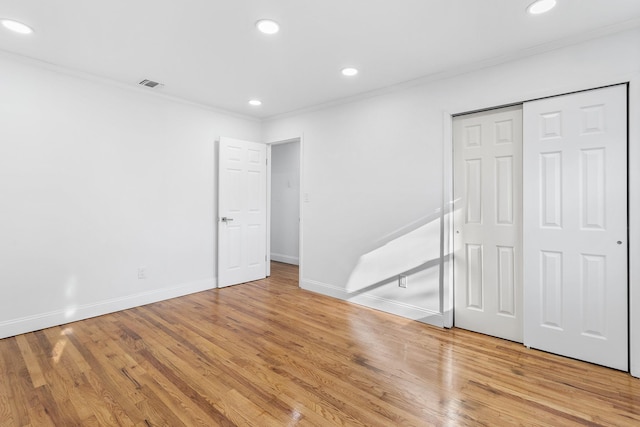 spare room with hardwood / wood-style flooring and ornamental molding