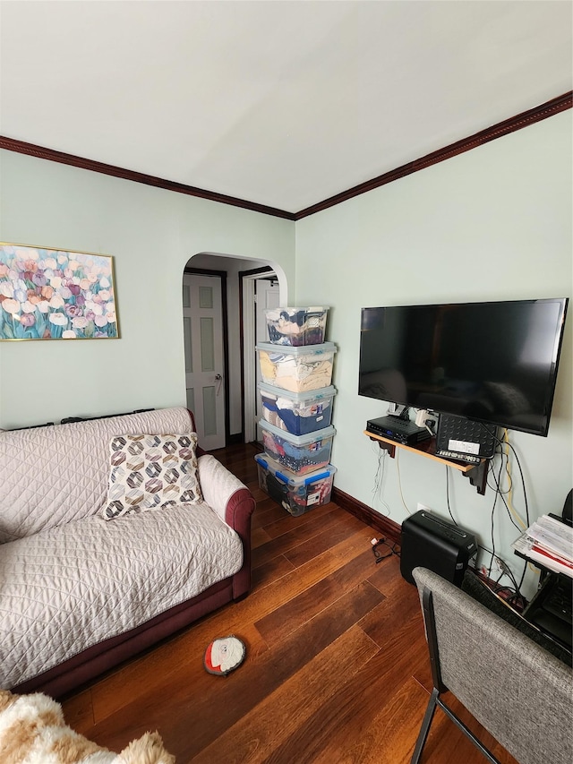 living room with dark hardwood / wood-style flooring and crown molding