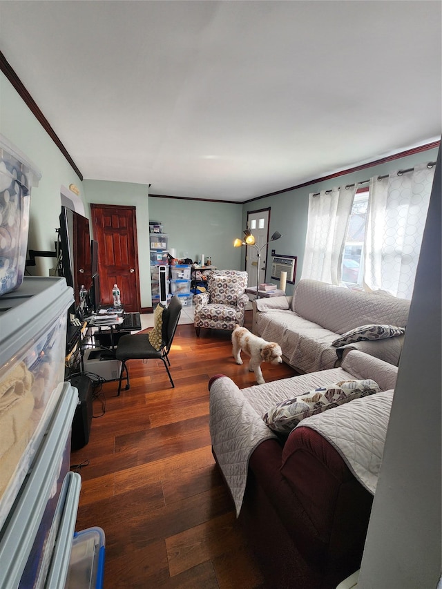 living room with dark hardwood / wood-style flooring and crown molding