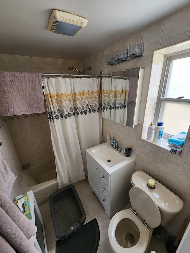 full bathroom featuring tile patterned flooring, shower / bath combo, toilet, and tile walls