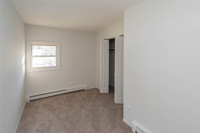 unfurnished bedroom with carpet floors, a baseboard radiator, and baseboards