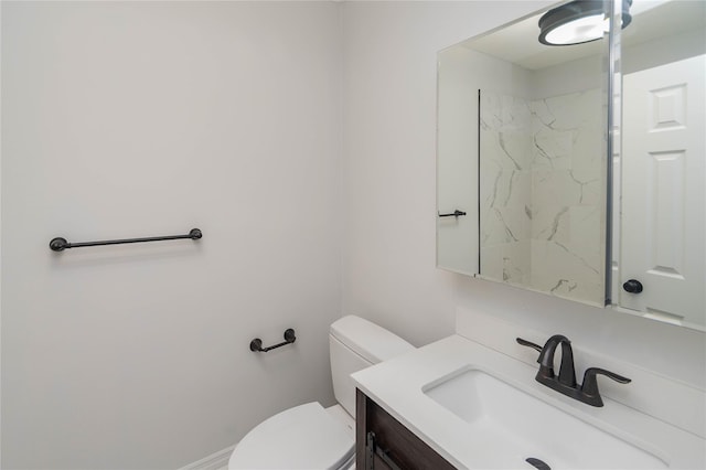 bathroom featuring toilet and vanity