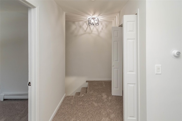 hall featuring carpet floors, stairway, baseboards, and a baseboard heating unit