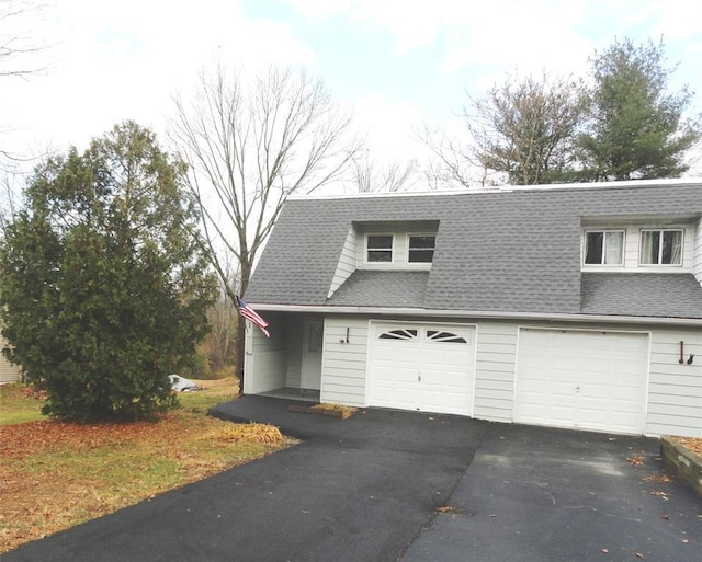 view of front of property with driveway, a shingled roof, and an attached garage