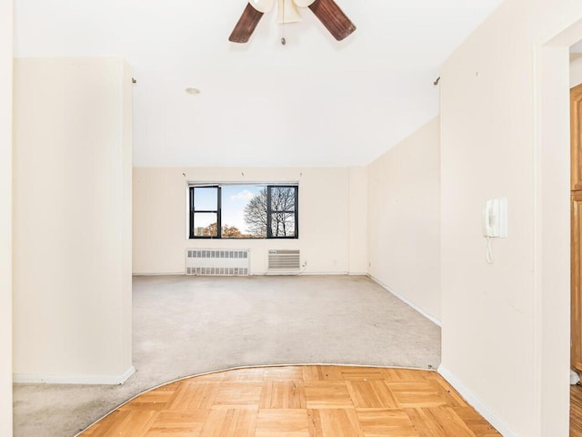 unfurnished living room featuring light carpet, radiator heating unit, ceiling fan, and lofted ceiling