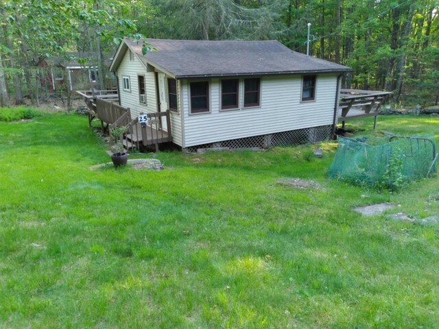 25 W Highland Dr, Smallwood, NY 12720 - view of side of home with a lawn, a wooden deck, and a shingled roof