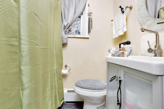 bathroom featuring a shower with shower curtain, vanity, toilet, and baseboard heating