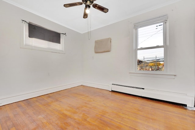 spare room featuring ceiling fan, ornamental molding, a baseboard radiator, and light hardwood / wood-style floors