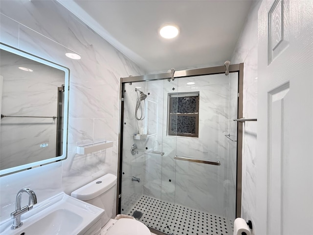 bathroom with vanity, a shower with shower door, tile walls, and toilet