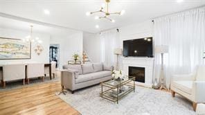 living room with wood-type flooring and a chandelier