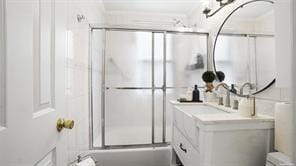 bathroom with vanity and bath / shower combo with glass door