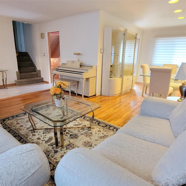 living room featuring crown molding and hardwood / wood-style flooring