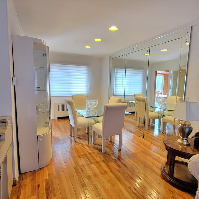 dining space featuring plenty of natural light, light wood-type flooring, and radiator