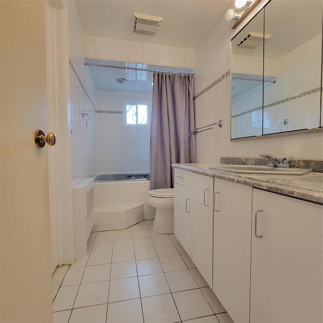 full bathroom featuring shower / bath combo, vanity, tile patterned flooring, toilet, and tile walls