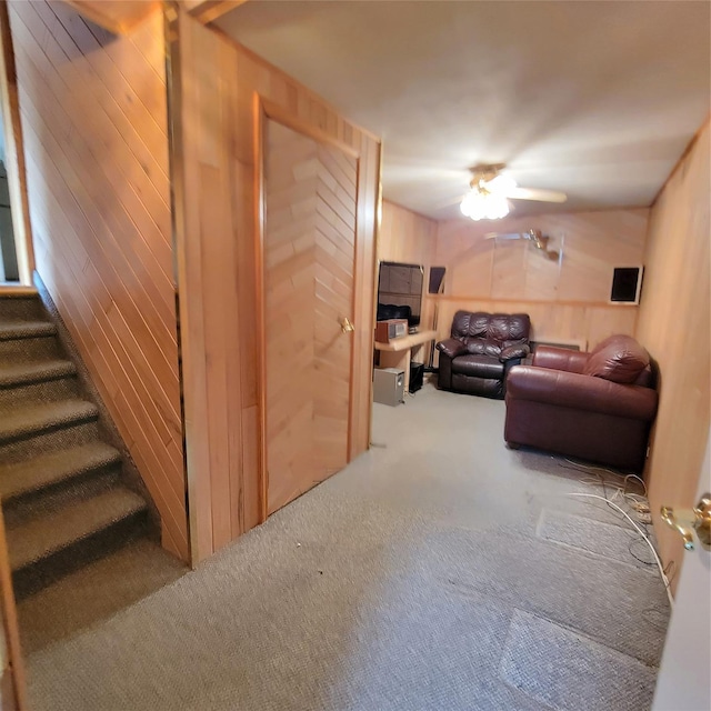 living room featuring wooden walls and carpet