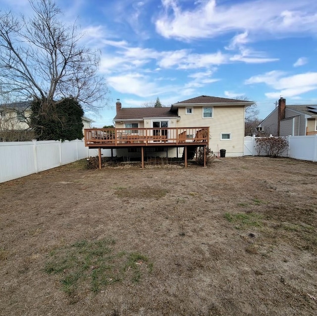 rear view of house with a wooden deck