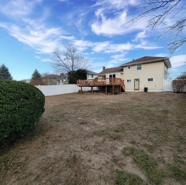 rear view of property with a wooden deck