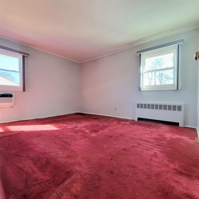 spare room with radiator, an AC wall unit, and carpet