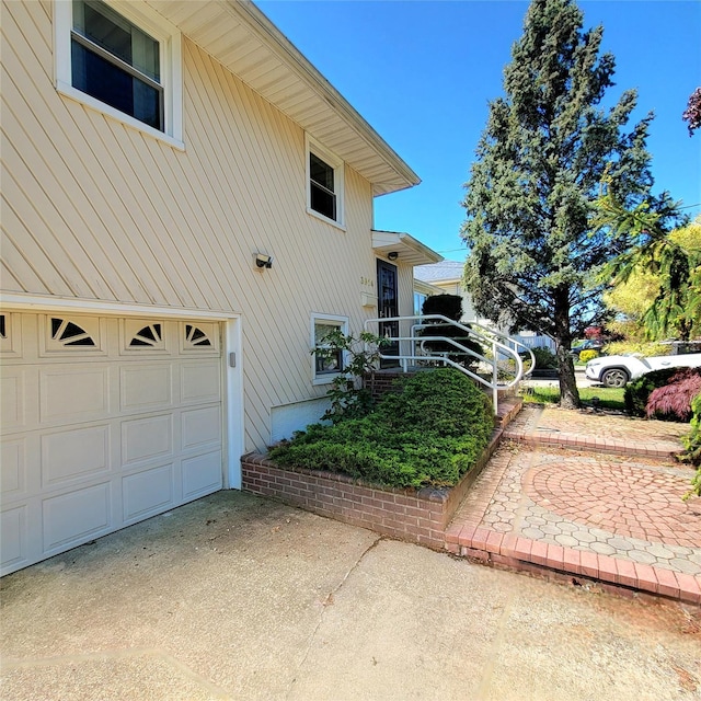 3914 Jerusalem Ave, Seaford, NY 11783 - view of side of property with a garage and concrete driveway