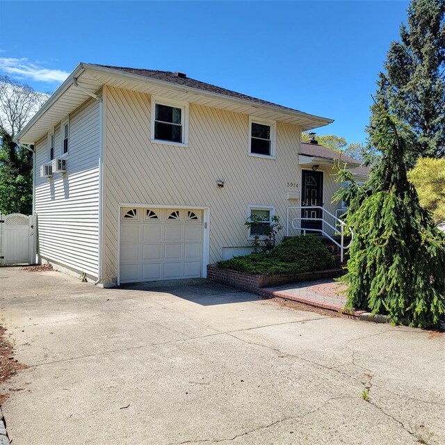 3914 Jerusalem Ave, Seaford, NY 11783 - view of front facade featuring concrete driveway and an attached garage