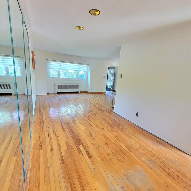 3914 Jerusalem Ave, Seaford, NY 11783 - unfurnished living room with radiator and light wood-style floors
