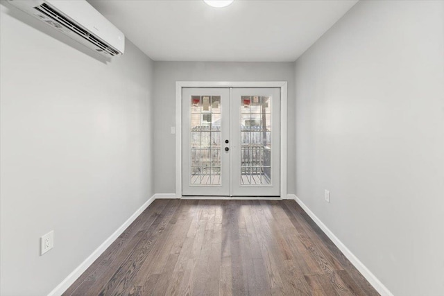 entryway with a wall mounted air conditioner, dark hardwood / wood-style flooring, and french doors