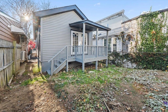 rear view of property with central AC