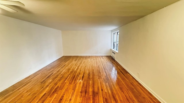 unfurnished room with wood-type flooring and ceiling fan