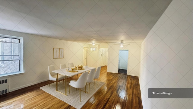 dining room featuring radiator heating unit and dark hardwood / wood-style flooring