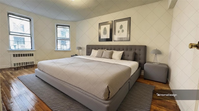 bedroom with radiator heating unit and dark wood-type flooring