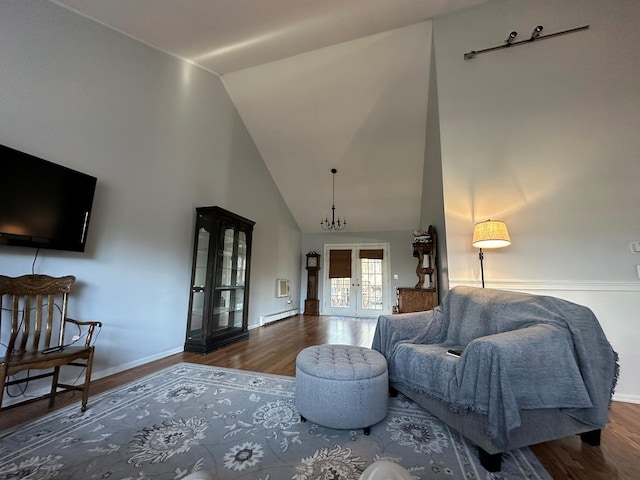 living room featuring a notable chandelier, vaulted ceiling, dark wood-type flooring, and french doors