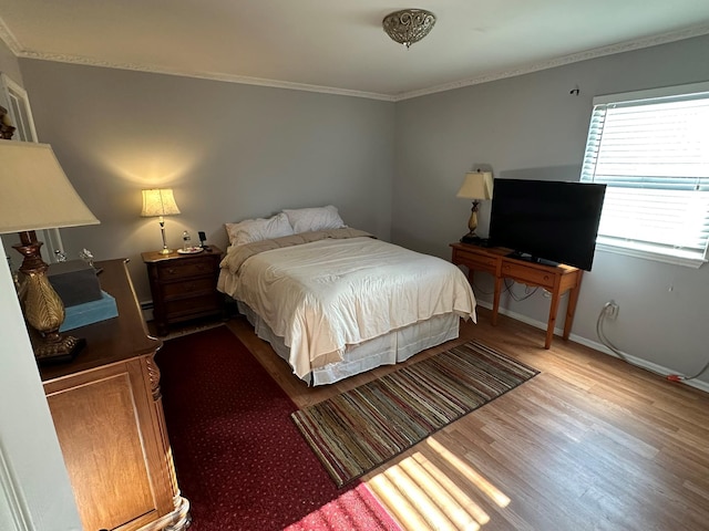 bedroom with hardwood / wood-style flooring and crown molding