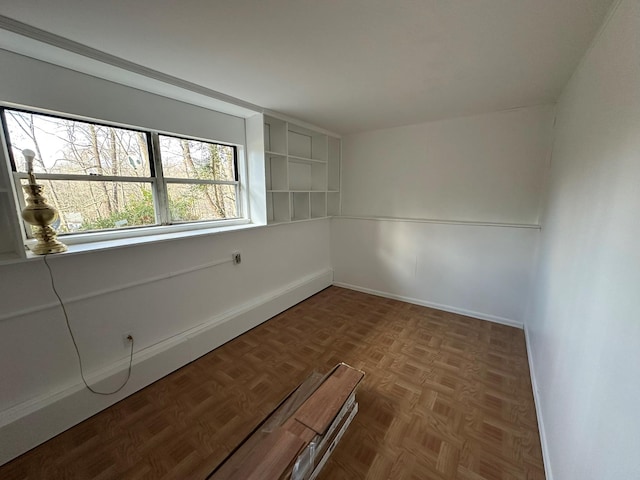 unfurnished room featuring parquet floors