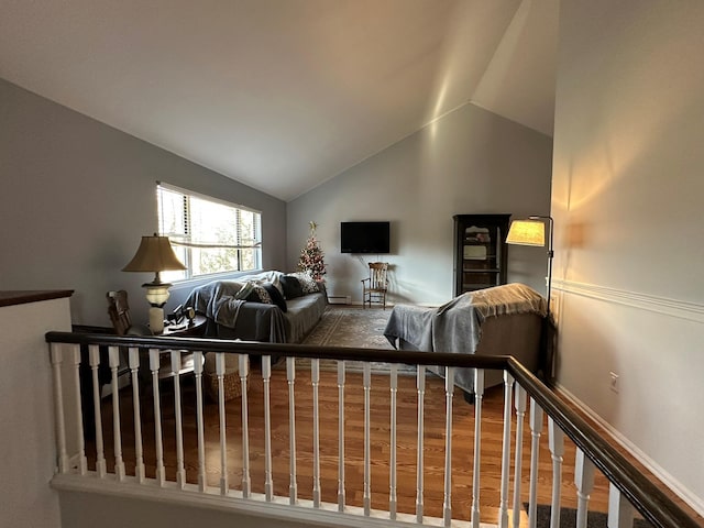 bedroom with hardwood / wood-style flooring and lofted ceiling