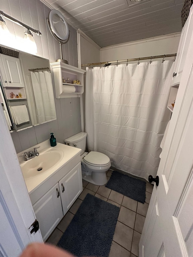 bathroom with tile patterned flooring, vanity, toilet, and ornamental molding