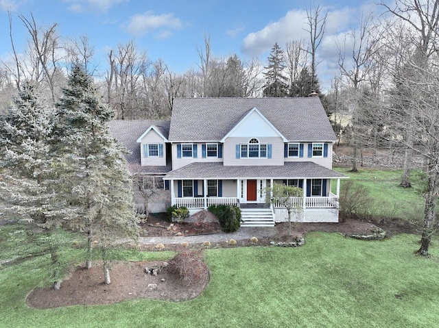 view of front of house with a front yard and covered porch