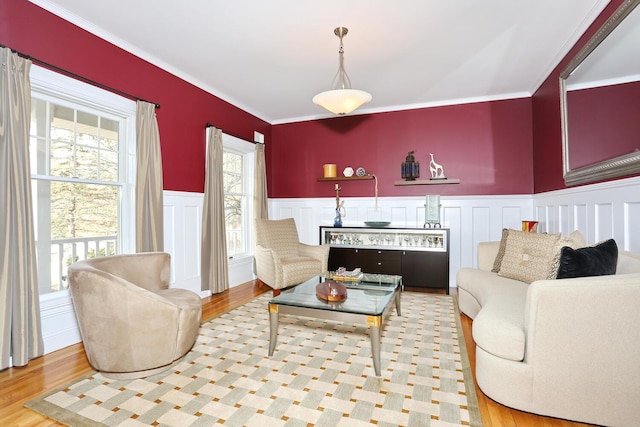 living room with ornamental molding and light wood-type flooring