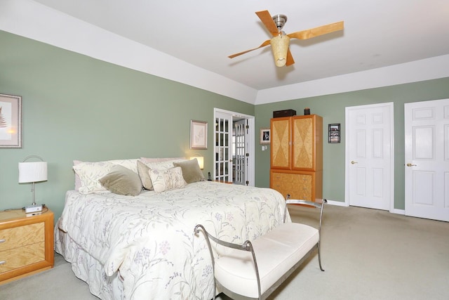 bedroom with ceiling fan and light carpet