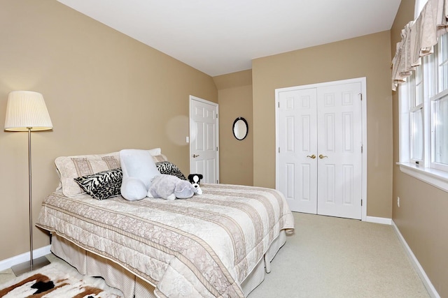 carpeted bedroom with a closet