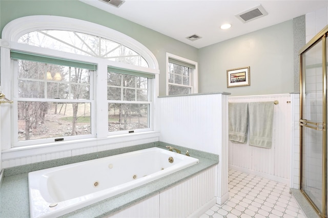 bathroom with a tub to relax in