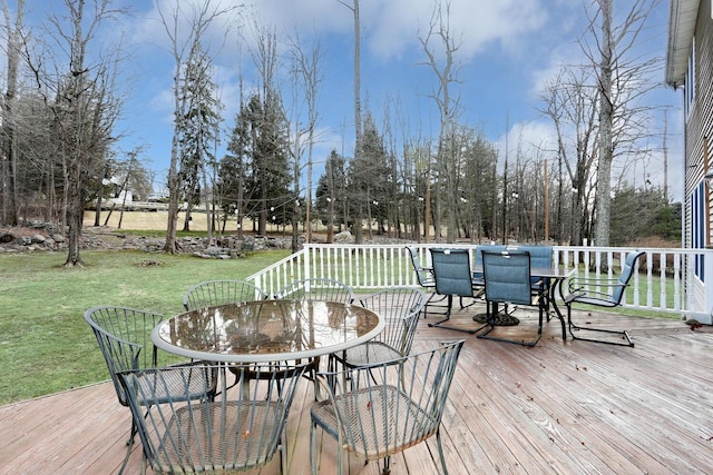 wooden deck featuring a lawn